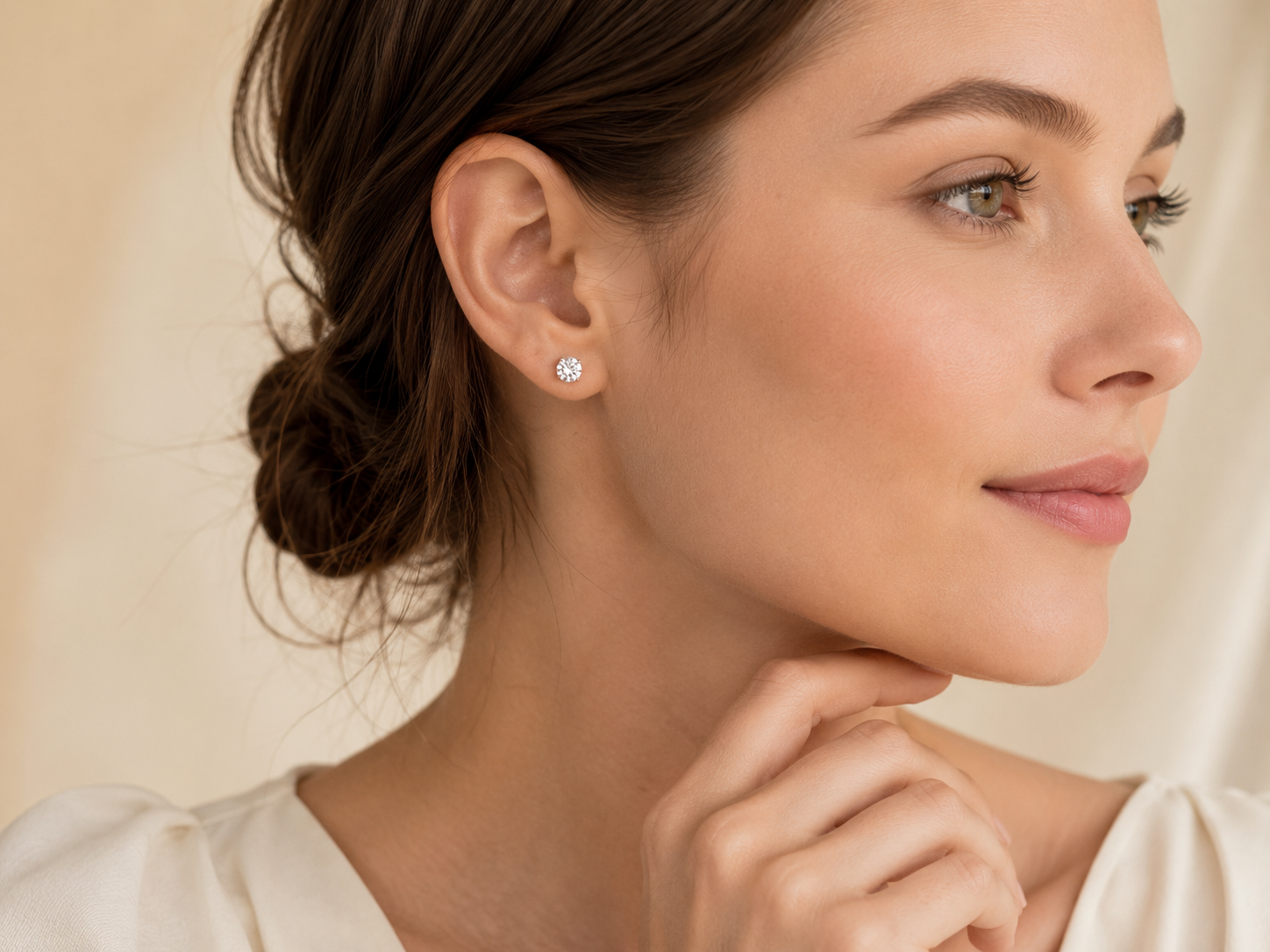 Woman wearing small moissanite stud earrings for natural everyday elegance
