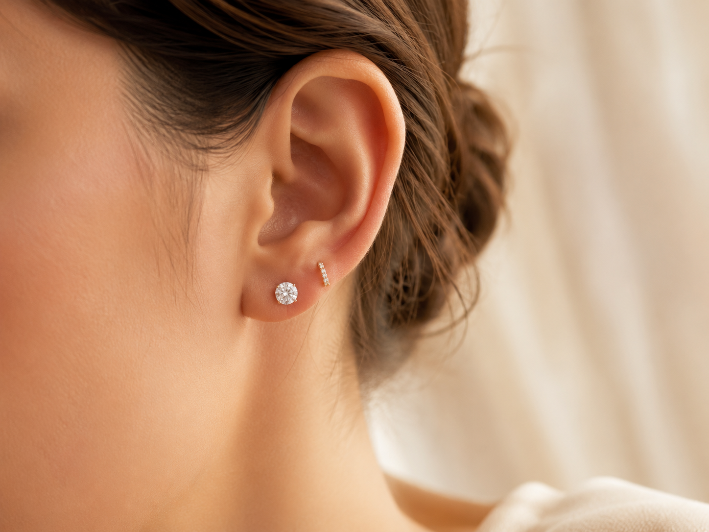 Close up of moissanite stud earrings worn on ear showing comfort and fit