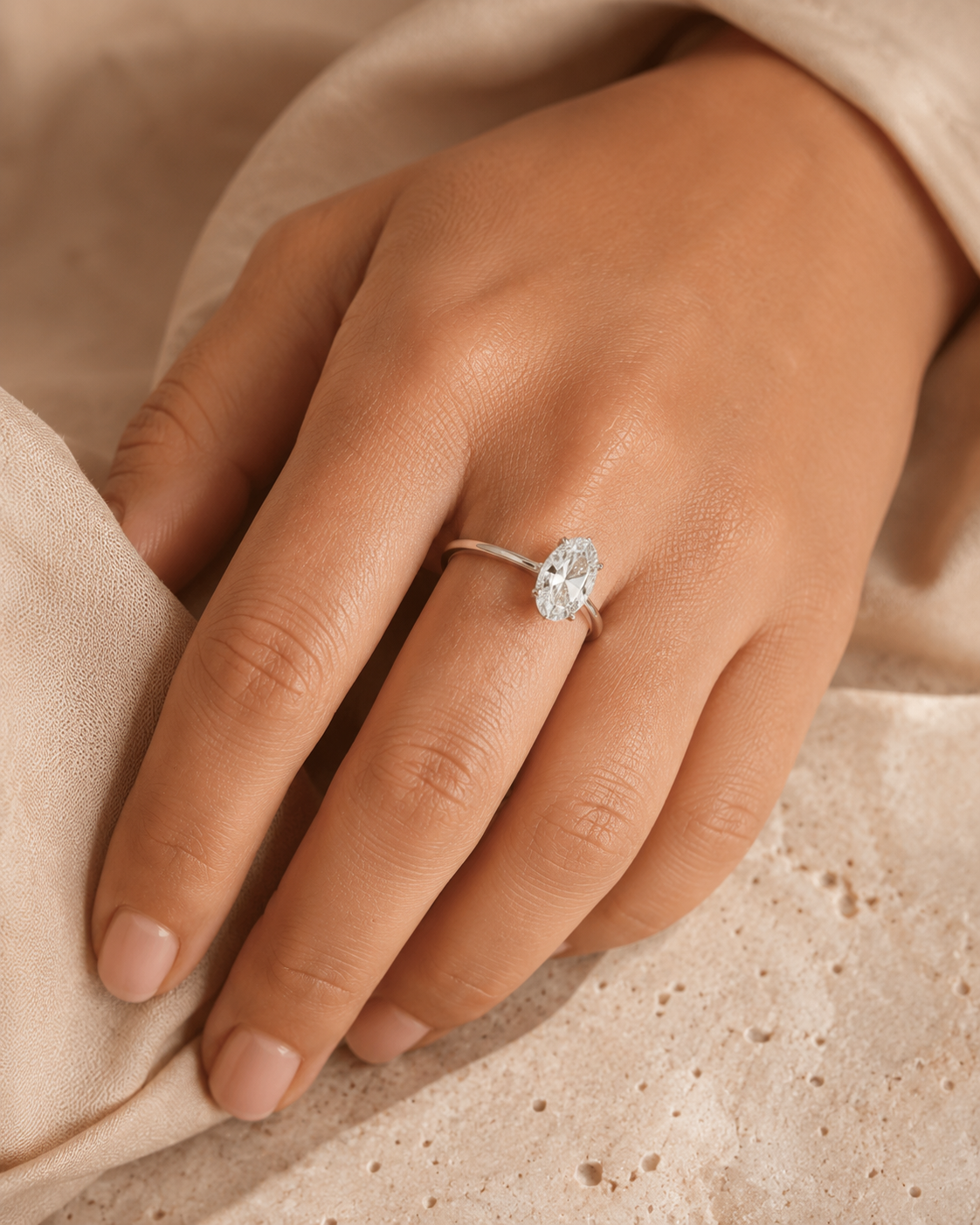 Oval moissanite solitaire ring worn on a woman's hand