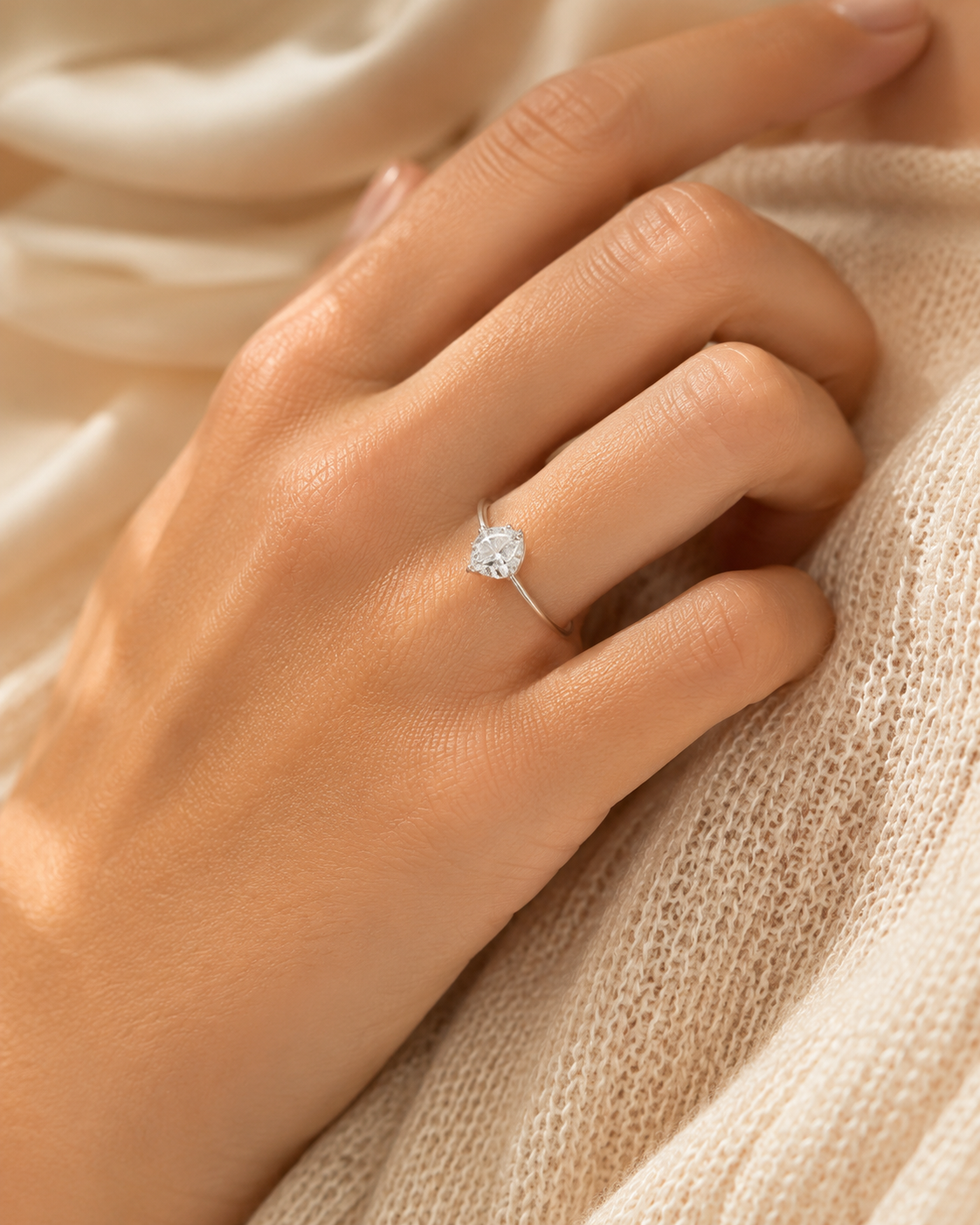 Pear shaped moissanite solitaire ring worn on a woman's finger