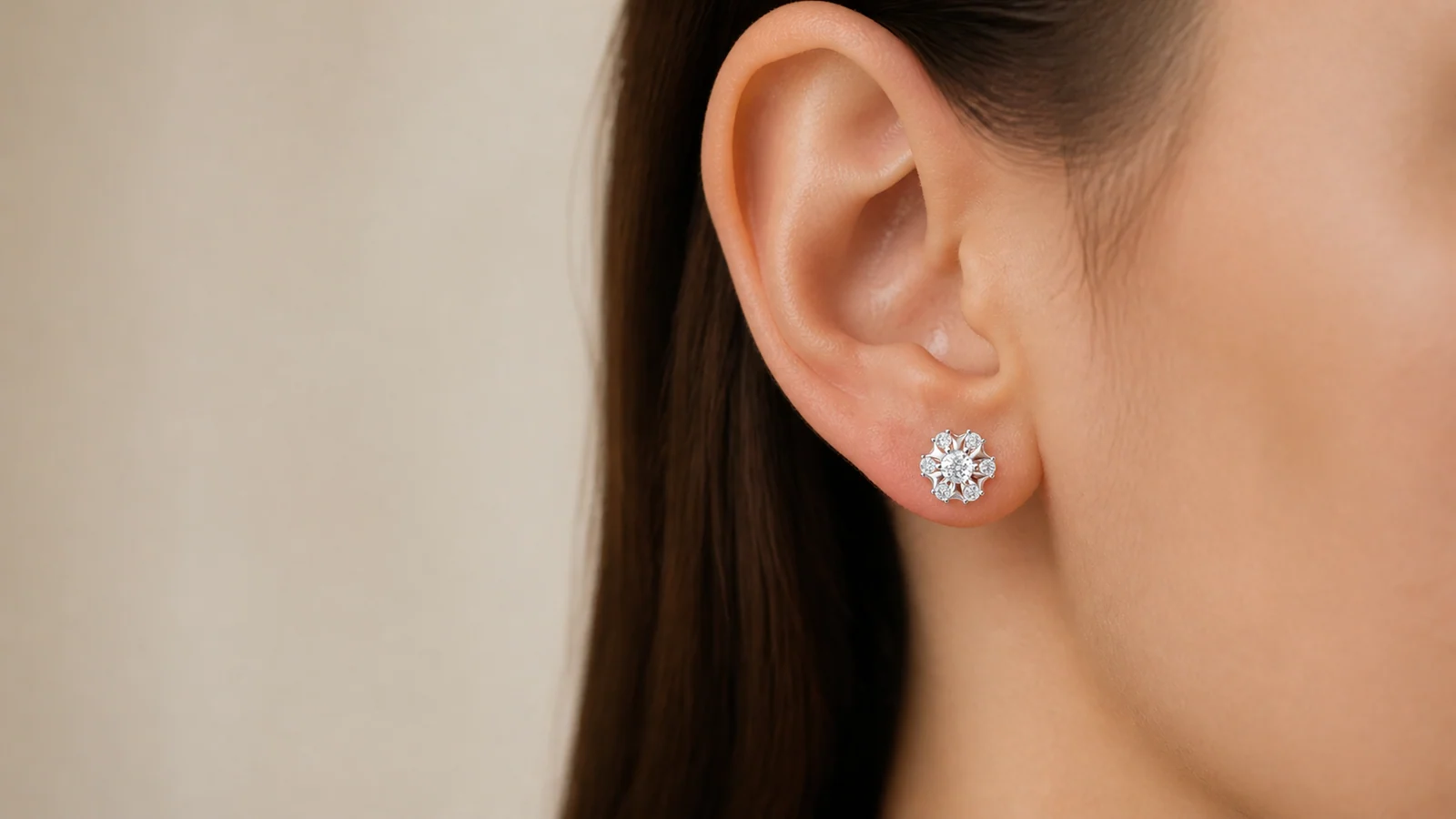 Sunburst Halo Moissanite Stud Earring shown centered on an adult earlobe