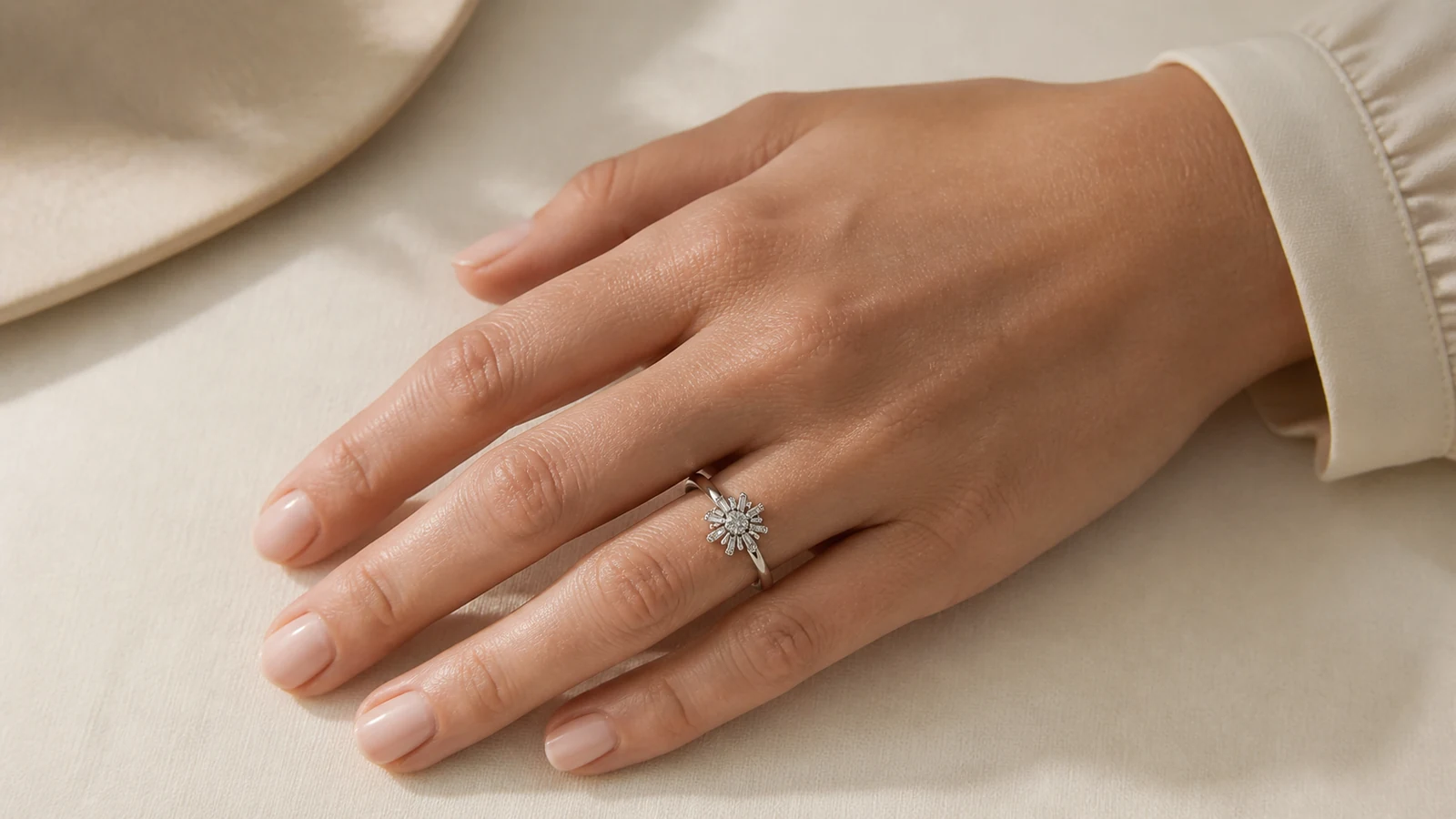 Woman wearing a generic silver-tone sunburst ring at realistic hand scale