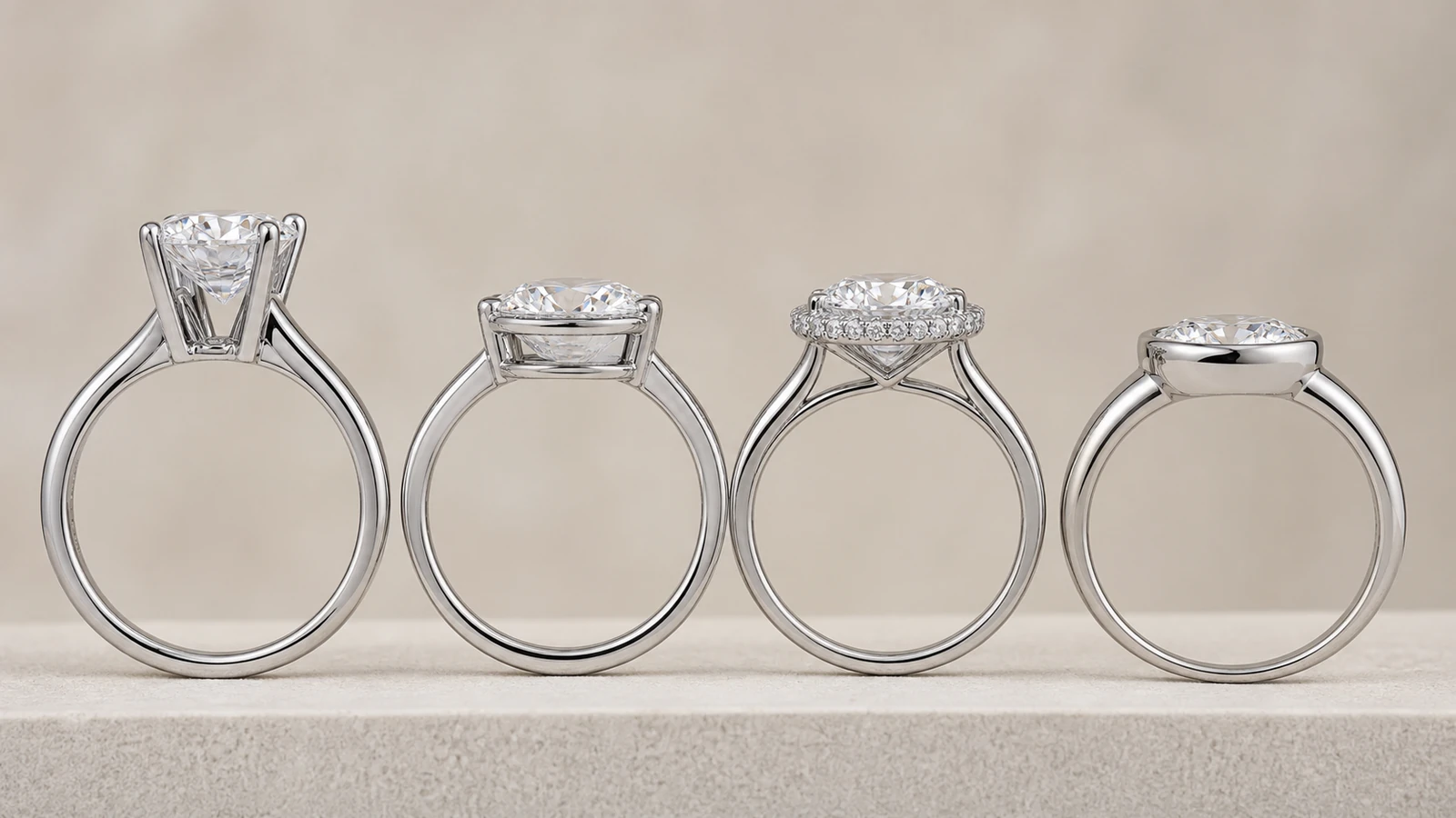 Side profiles of solitaire low basket halo and bezel inspired engagement ring settings