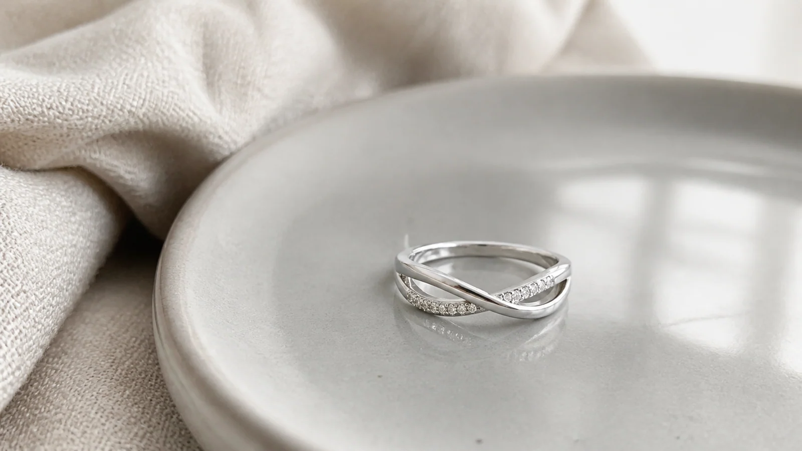 Twisted pavé stackable moissanite ring with crossing wave-shaped lines
