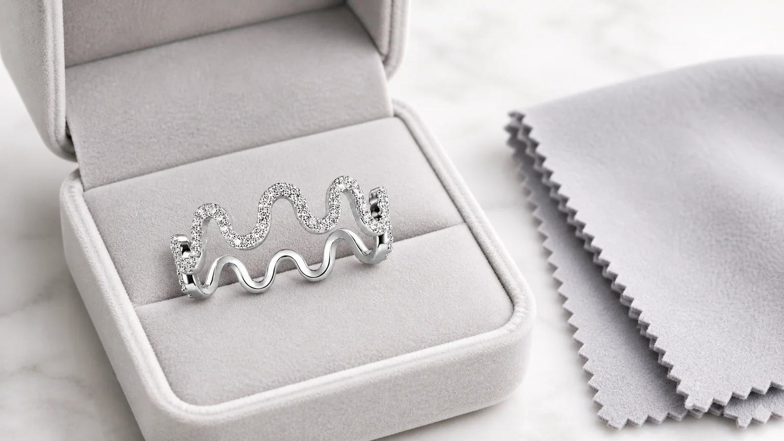 Wavy crown moissanite stackable ring stored in a soft jewelry box
