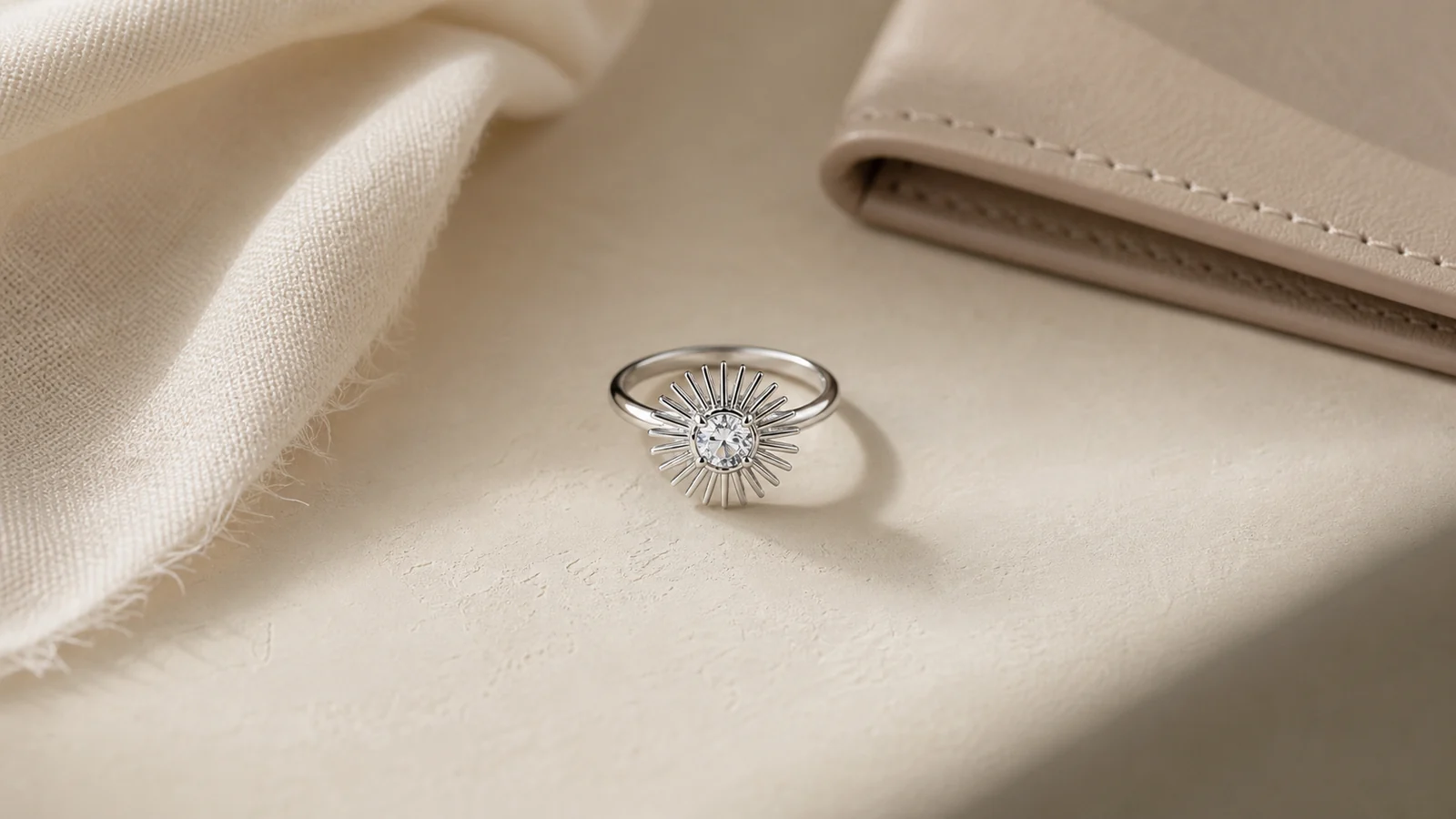 Generic sunburst-inspired ring styled as the focal point with quiet neutral accessories