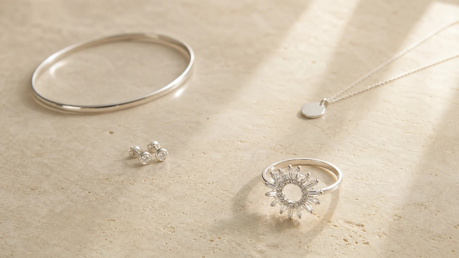 Generic radiant ring balanced with small stud earrings pendant and slim bracelet