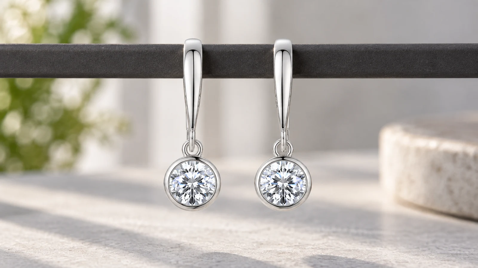 Bezel-set dangle earrings showing articulated construction