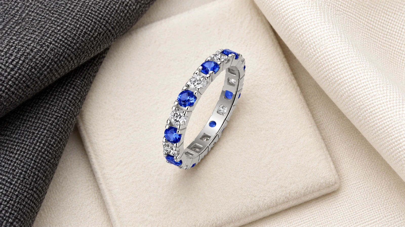 Blue and white eternity band arranged between charcoal and cream fabrics