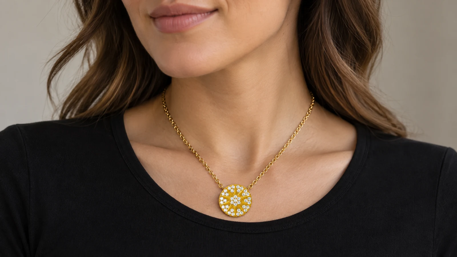 Sunburst moissanite sunshine pendant centered above a black crew neckline